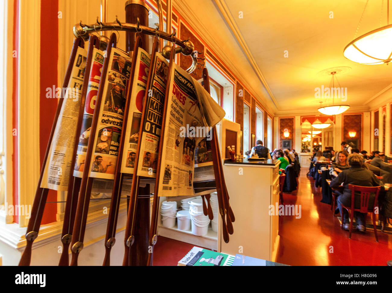 Various newspapers in Prague Cafe Louvre inside Czech Republic Stock Photo