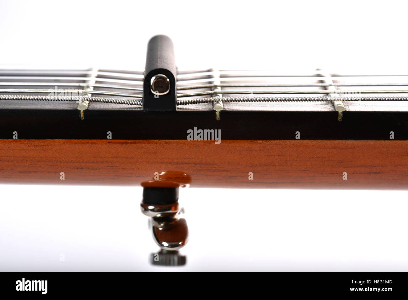 classical guitar, capodaster on the neck, illustrate the typical low action of a flamenco guitare, detailed view, capo, Stock Photo