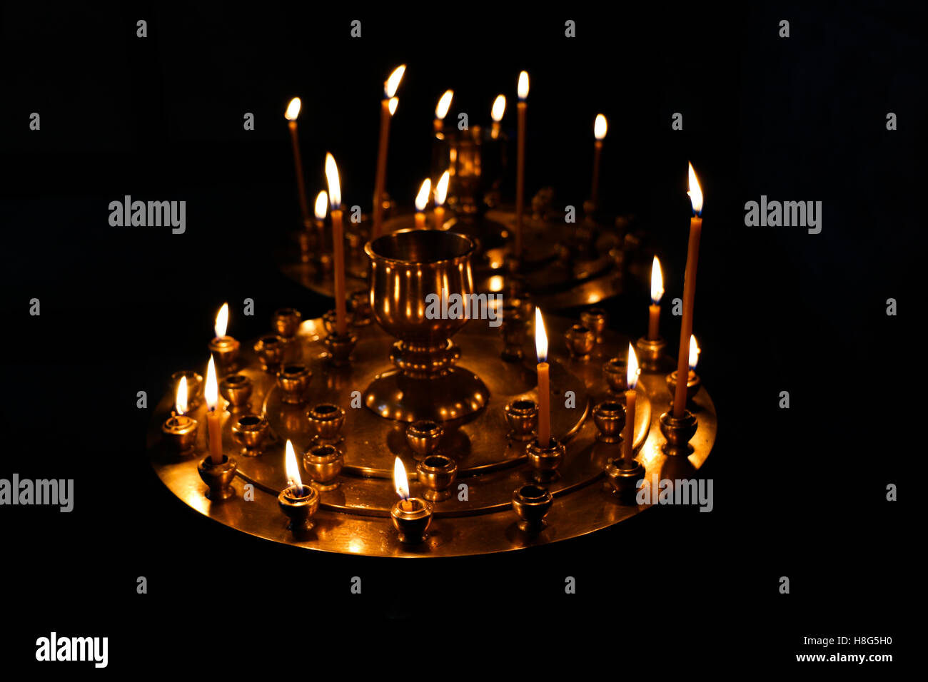Candles burning over dark background in a church Stock Photo - Alamy