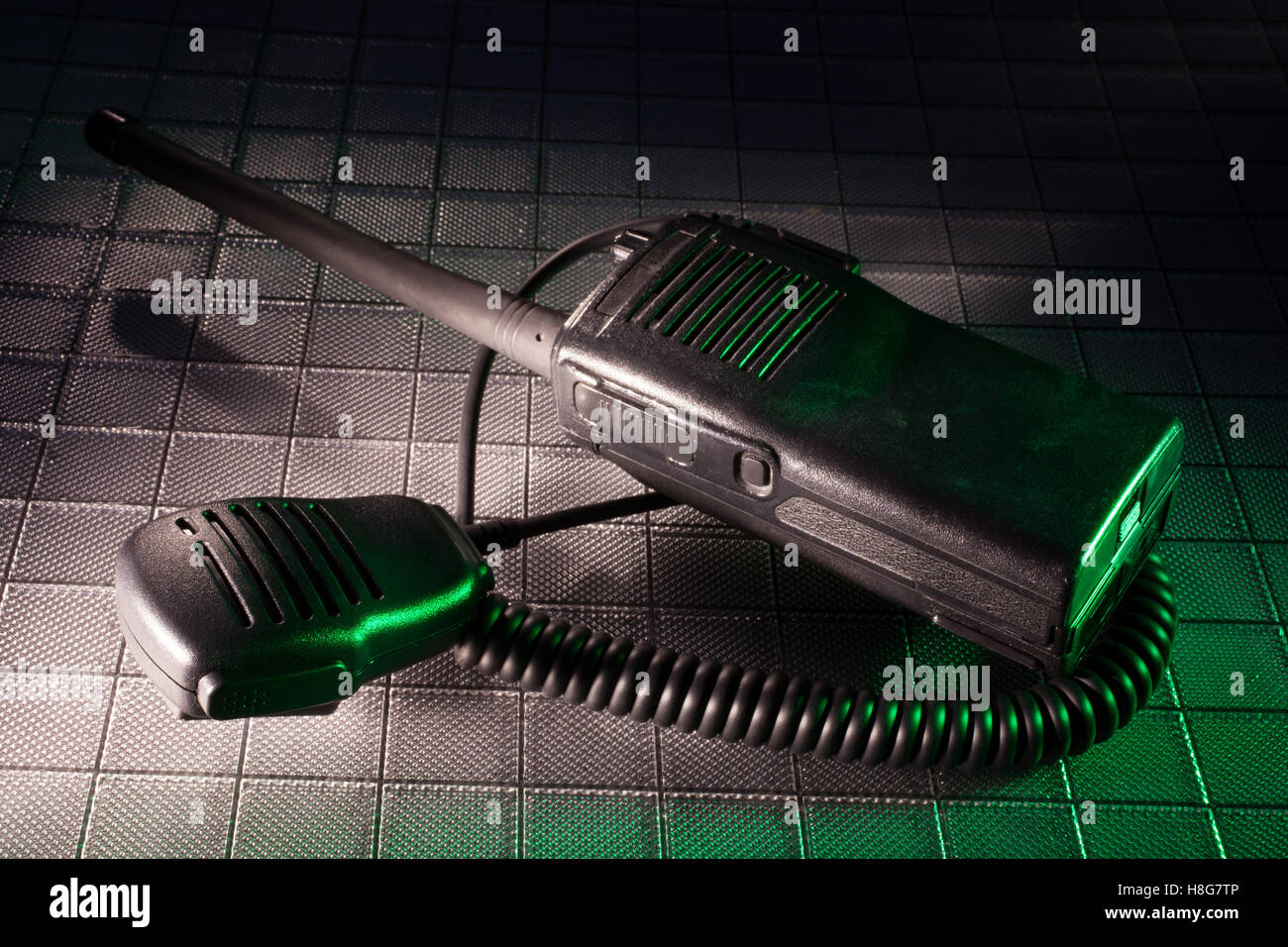 Two way radio and microphone with a green gel to the right Stock Photo