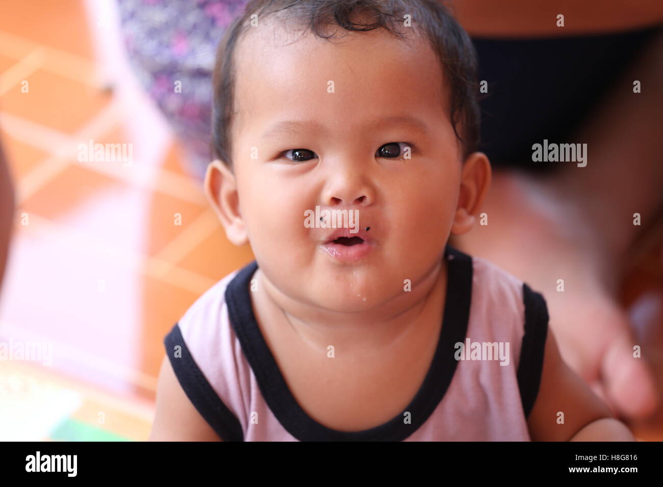 Asian baby eating a dragon fruit with happily,concept of health and
