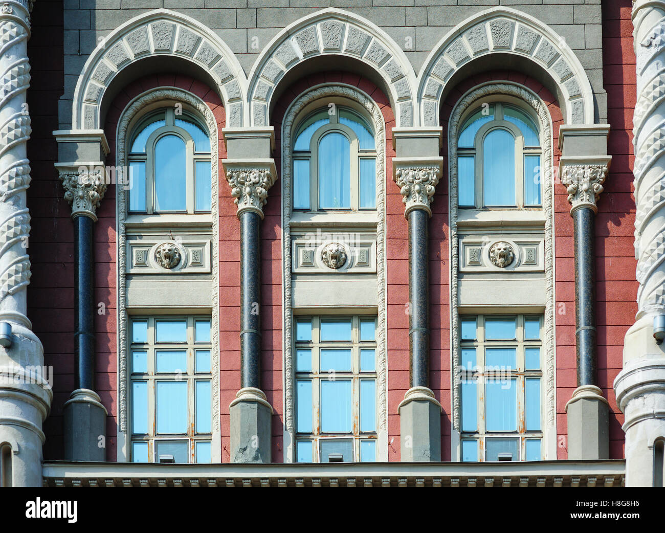 Windows with arches in old architectural building Stock Photo