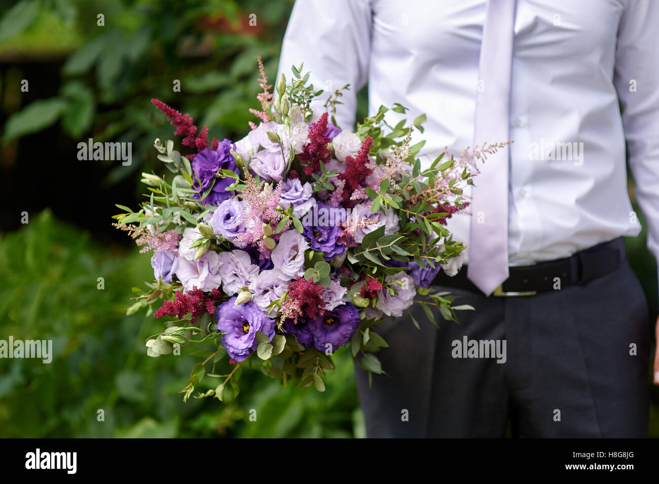 groom holding a beautiful bridal bouquet bride Stock Photo