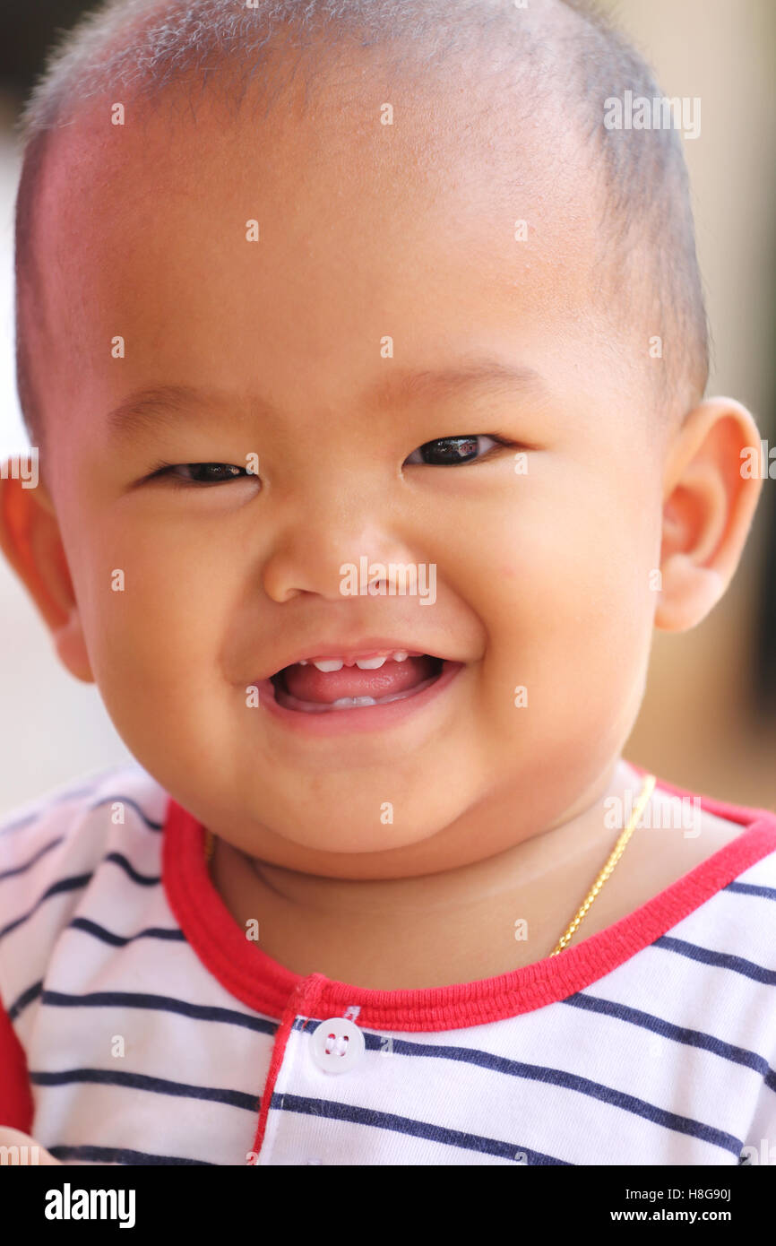 Asian baby of toddler and have teething in smile with happily,concept of health and development of the children. Stock Photo