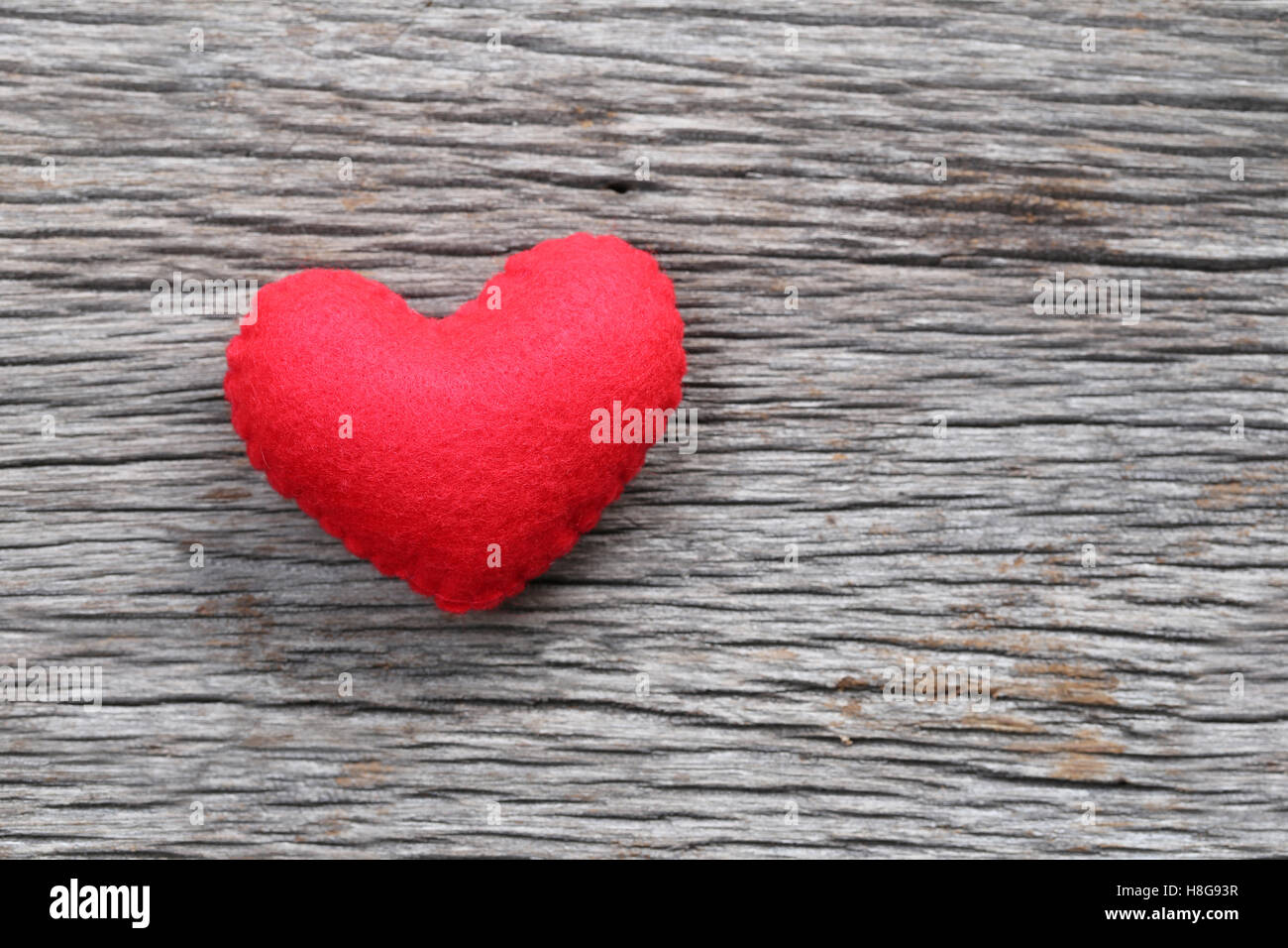 Red heart is placed on a wooden floor concept of love in Valentine's Day. Stock Photo