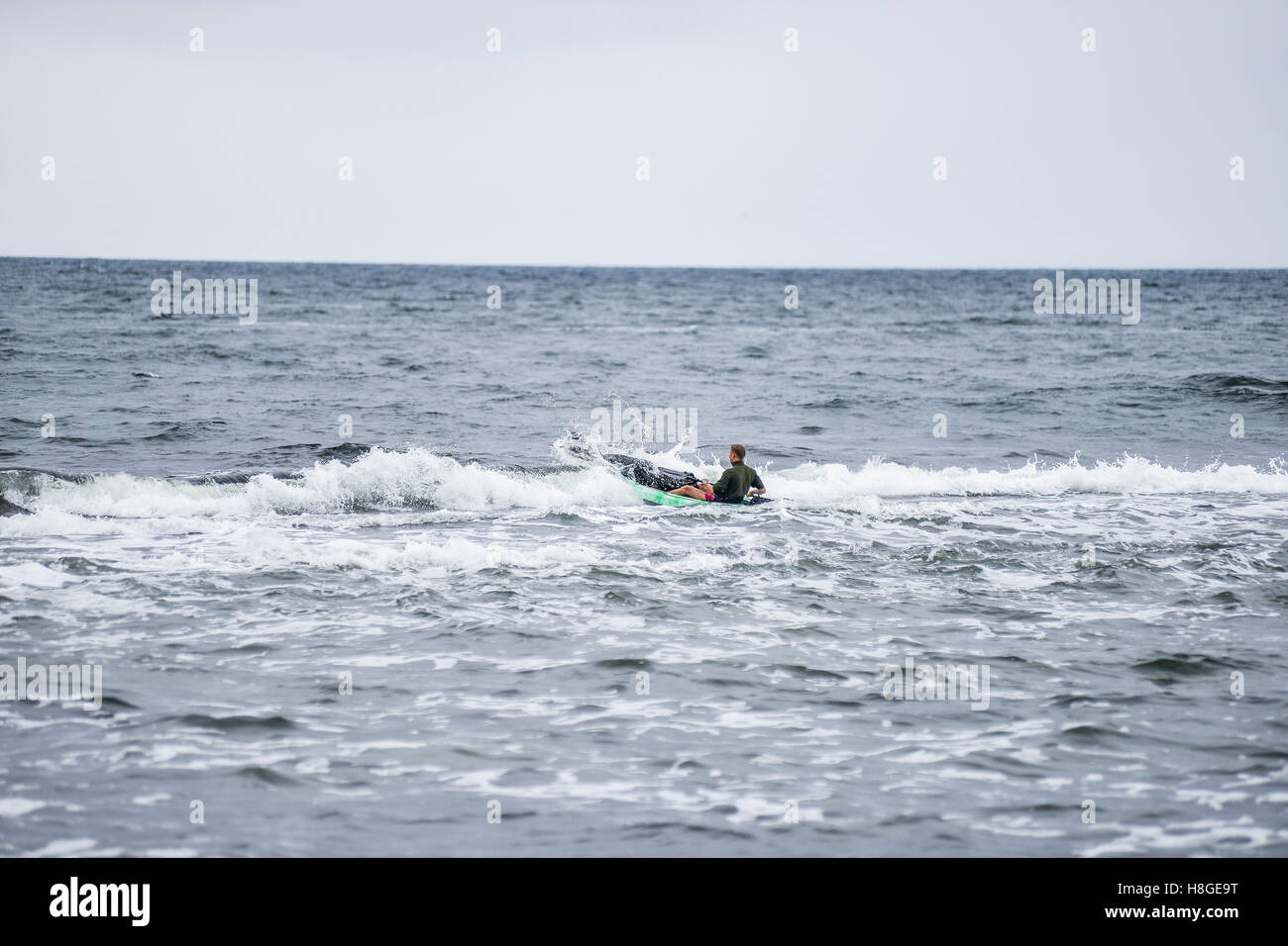Kayak surfer over the crest of a wave Stock Photo - Alamy