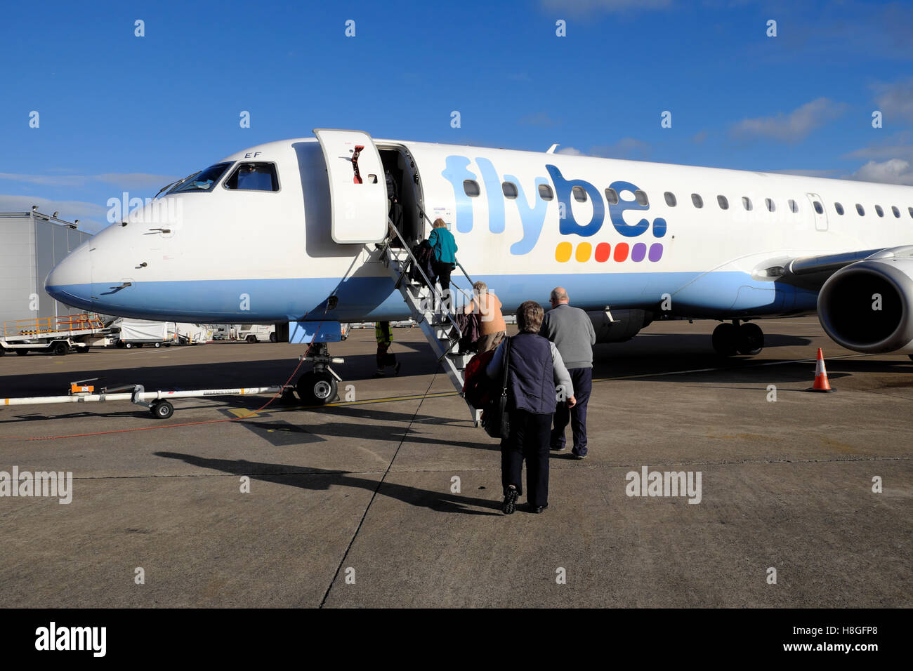 Flybe passengers boarding a plane on the tarmac at Cardiff Airport,  Wales UK  KATHY DEWITT Stock Photo
