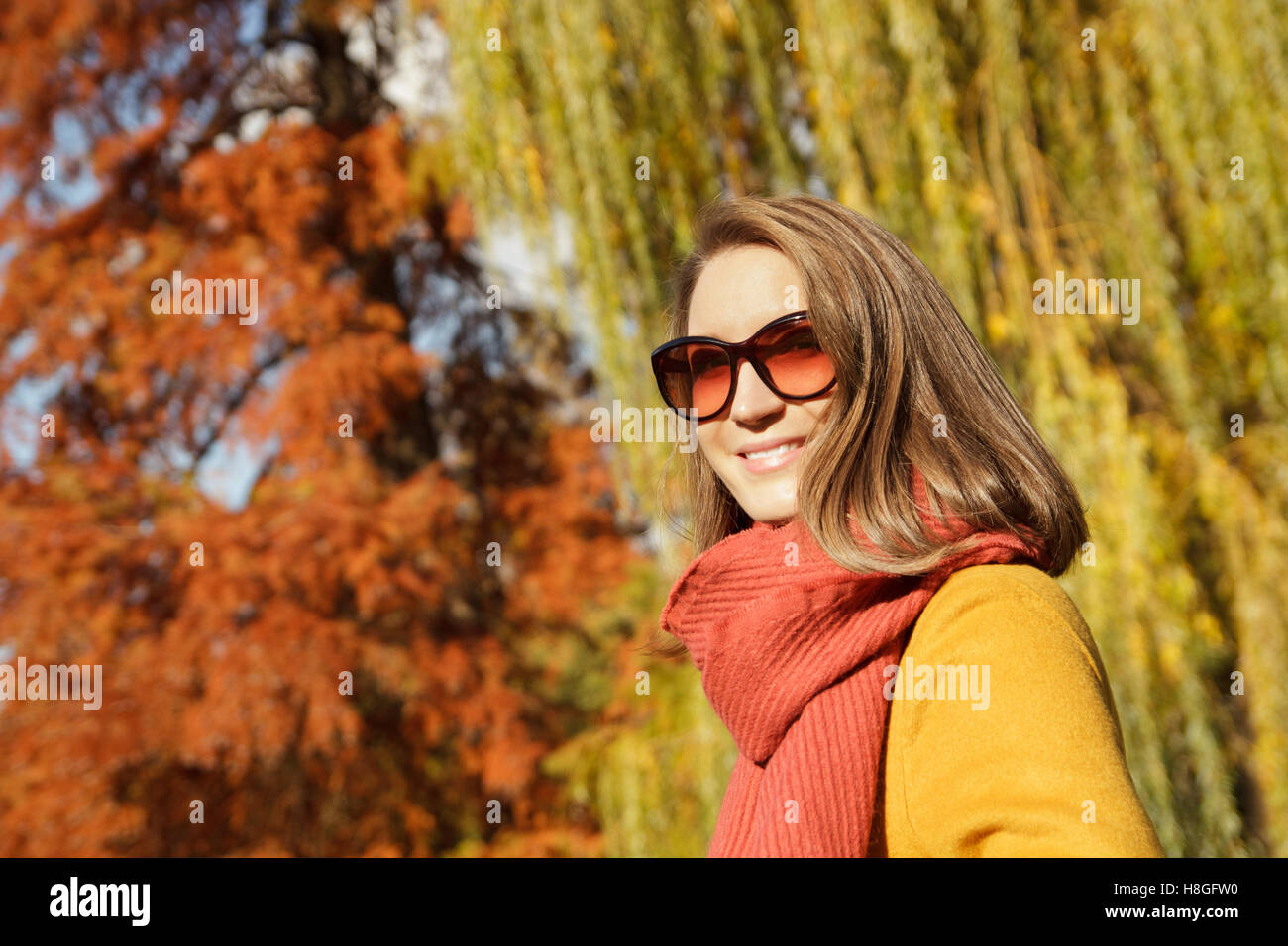 Young fashionable woman posing in autumn park Stock Photo - Alamy
