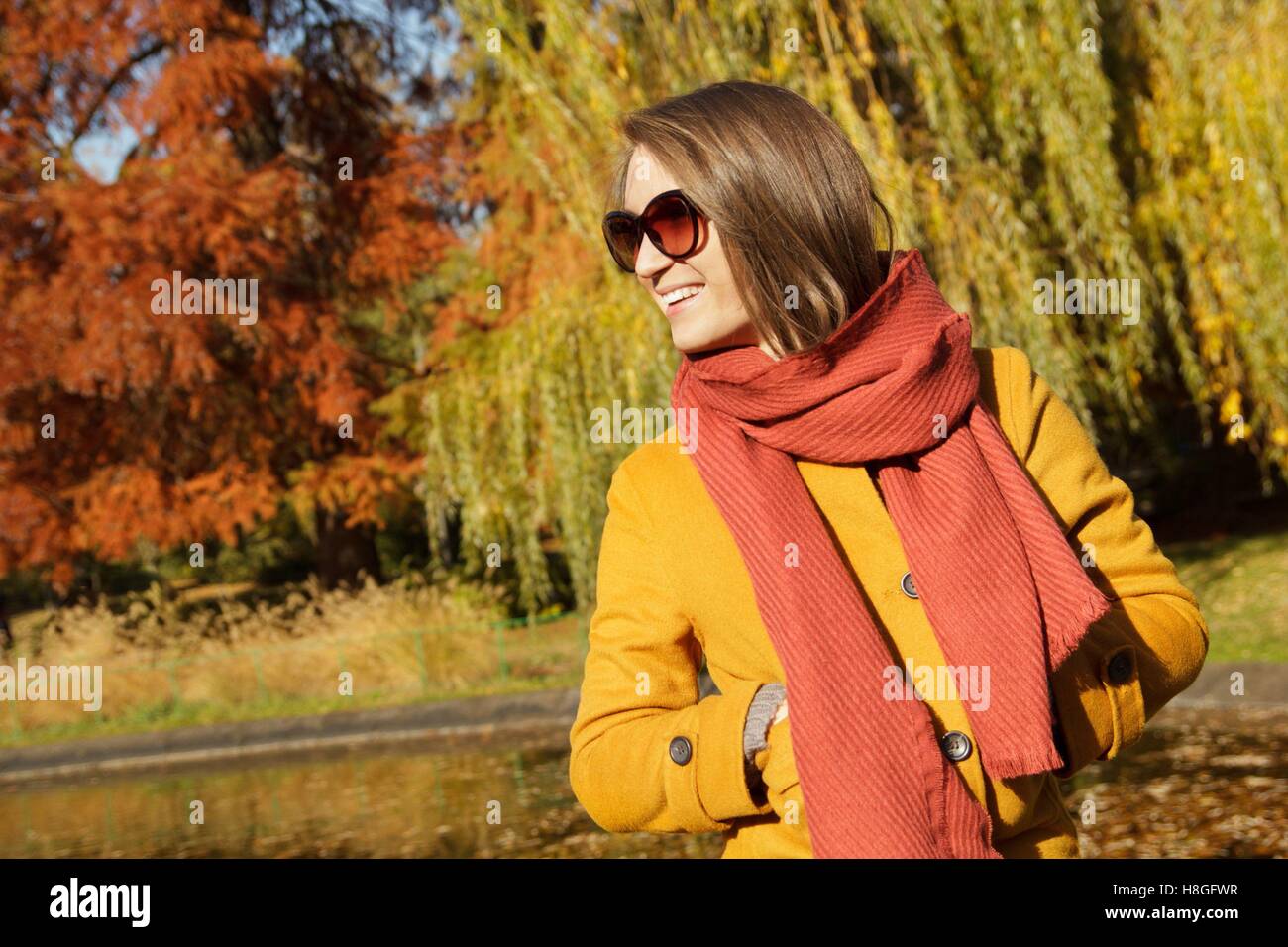 Young fashionable woman posing in autumn park Stock Photo - Alamy