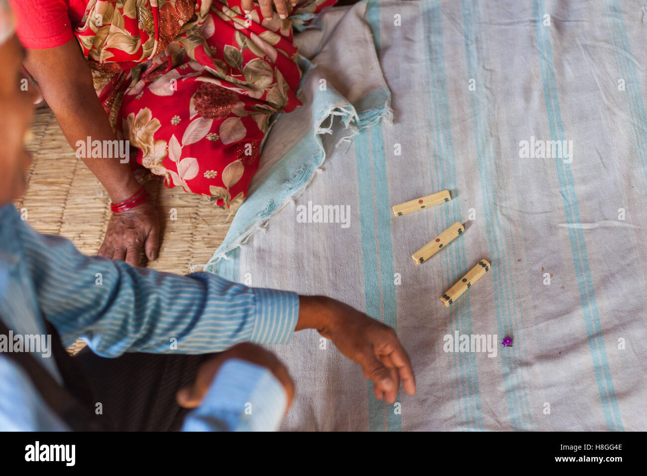 Playing Pasa dice in rural Nepal Stock Photo