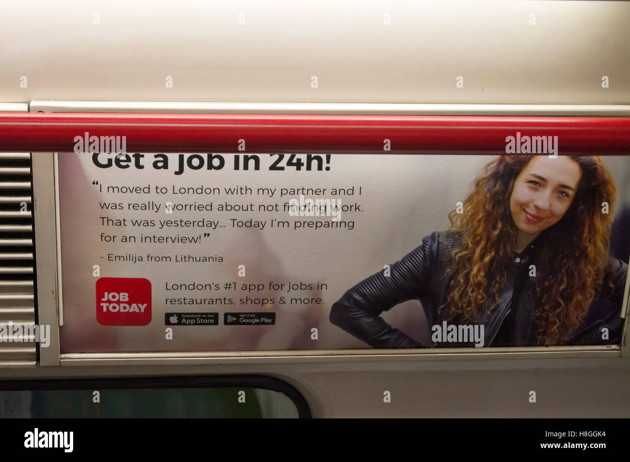 An advert for a job-finding smartphone app aimed at Eastern European immigrants on a Central Line London Underground Tube train Stock Photo