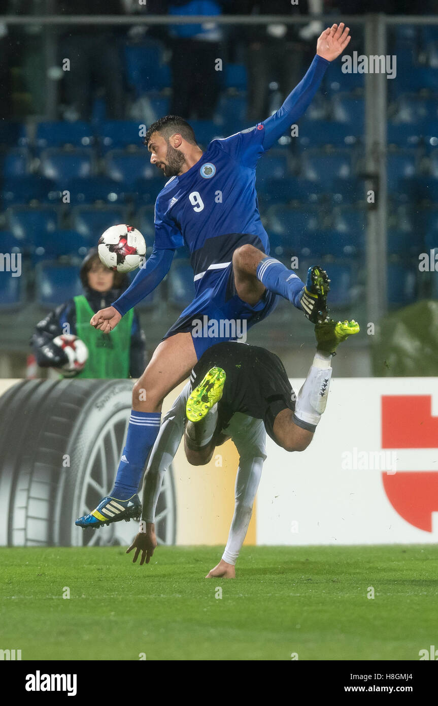 Serravalle, San Marino. 11th Nov, 2016. Germany's Benjamin Henrichs (BELOW) and Mattia Stefanelli from San Marino vie for the ball during the World Cup qualifier match between San Marino and Germany in Serravalle, San Marino, 11 November 2016. Photo: GUIDIO KIRCHNER/dpa/Alamy Live News Stock Photo