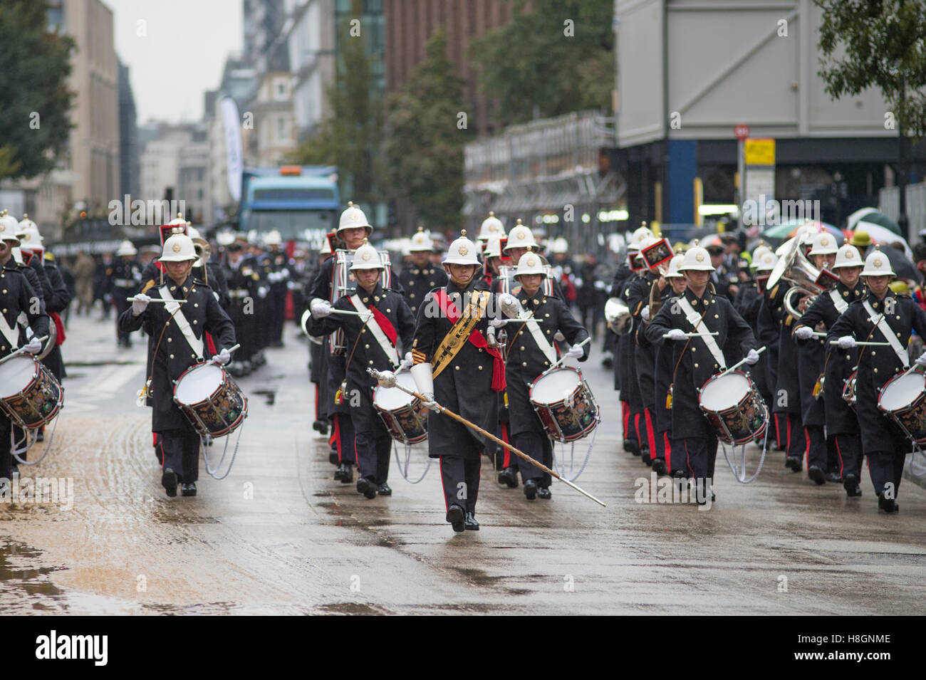 City of London, UK. 12th November, 2016. The world’s largest unrehearsed procession, The Lord Mayor’s Show, takes place through the City of London from the Guildhall to The Royal Courts of Justice on the Strand where Dr Andrew Parmley is sworn in on his first day in office. The ancient carnival is 801 years old this year and takes place in cold, wet weather in spite of which crowds line the route. Band of the Royal Marines on a rain soaked street. Credit:  Malcolm Park editorial/Alamy Live News. Stock Photo