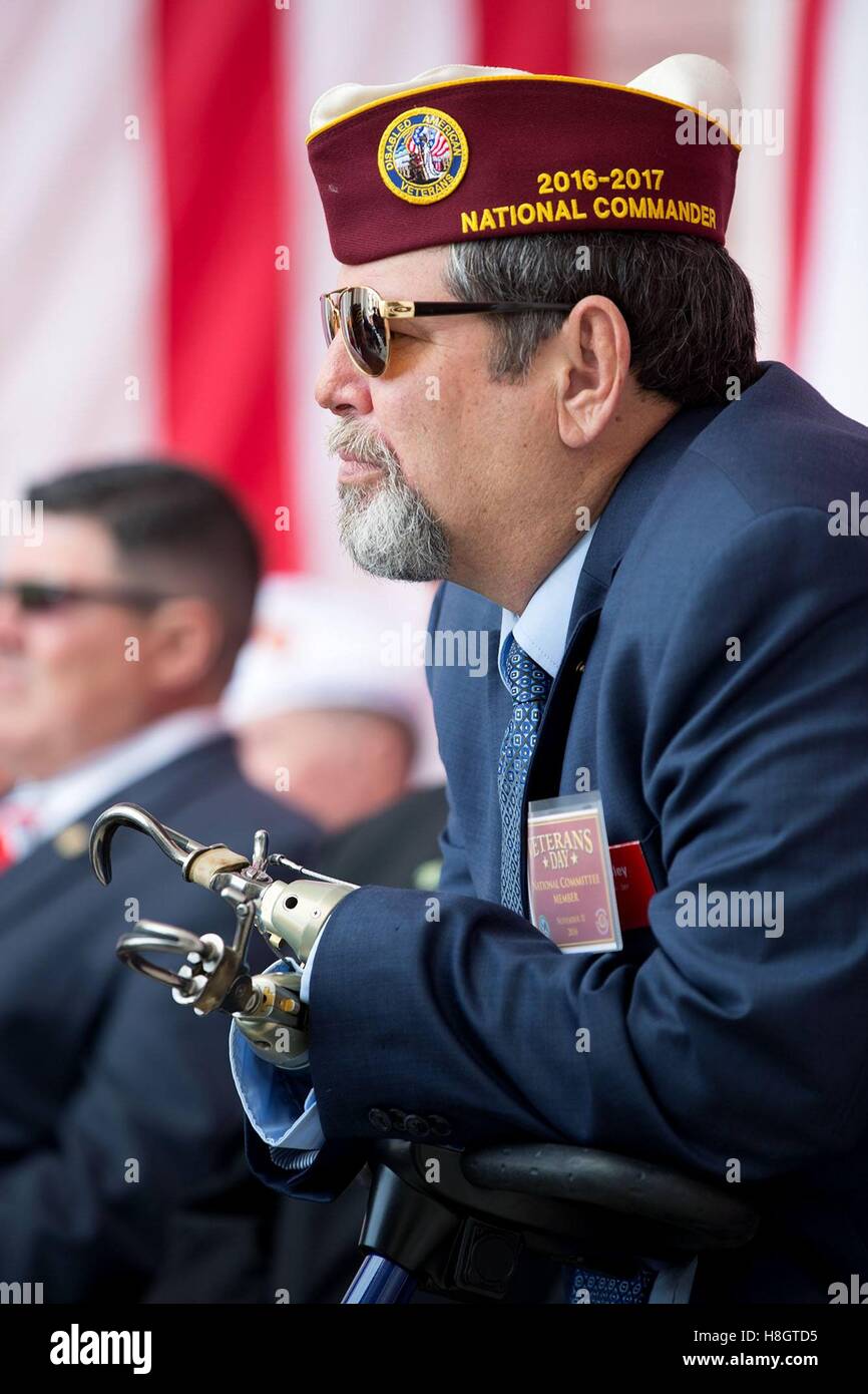 David Riley, National Commander of the Disabled American Veterans, listens to President Obama speak during a Veterans Day ceremony at the Memorial Amphitheater at Arlington National Cemetery November 11, 2016 in Arlington, Virginia. Stock Photo