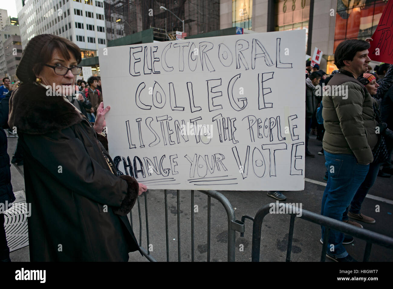 New York, USA. November 12, 2016. Woman holding sign urging electoral college to reject Donald Trump as president, during march from New York City's Union Square up 5th Avenue to the Trump Tower to protest against the election of Trump as 45th president of the U.S. Credit:  Joseph Reid/Alamy Live News Stock Photo