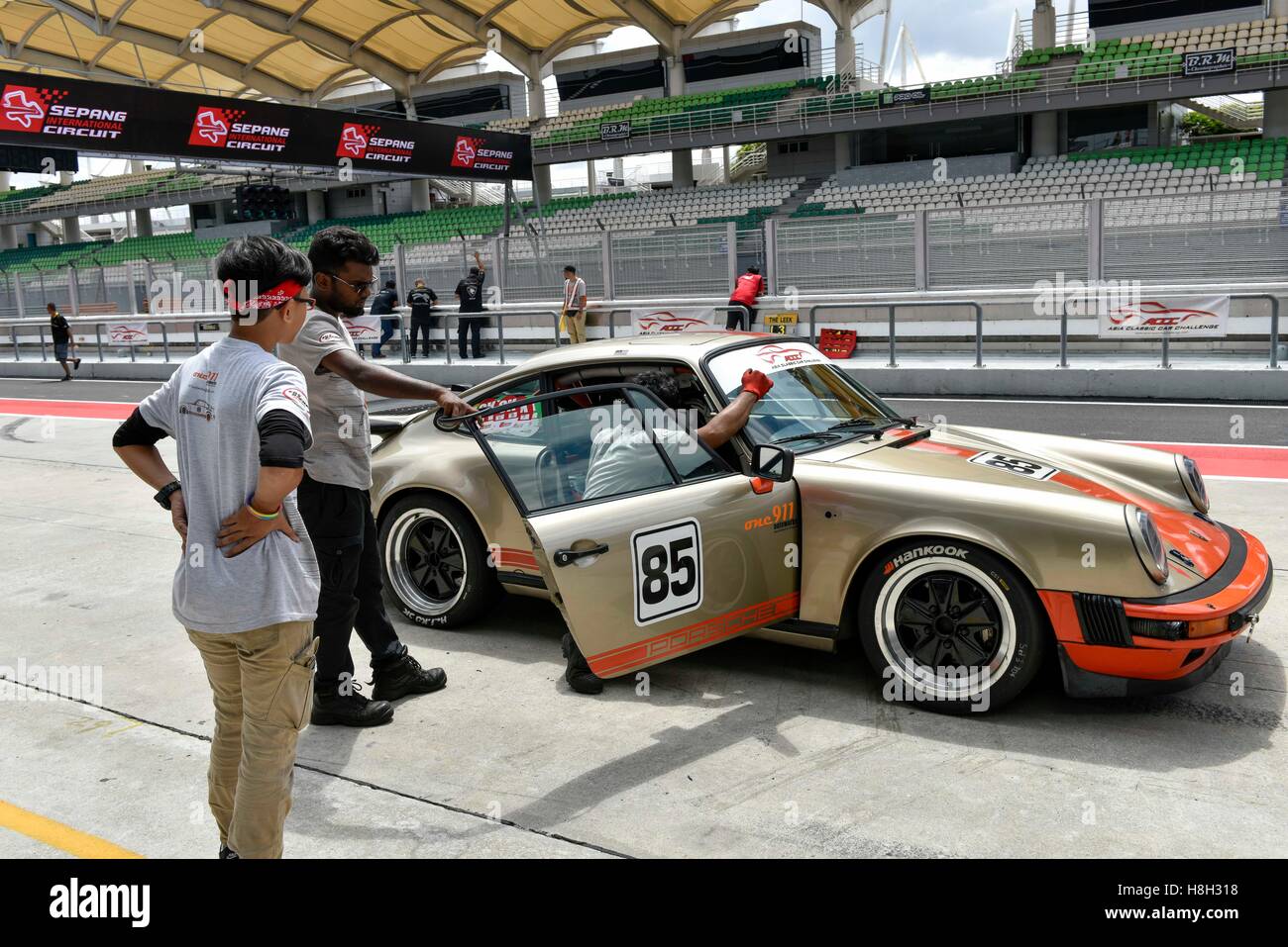 Team Peter Cardosa car crew members check the Porsche 911 Carrera on the paddock before the Asia Classic Car Challenge on November 12, 2016 at Sepang International Circuit in Kuala Lumpur, Malaysia. Stock Photo