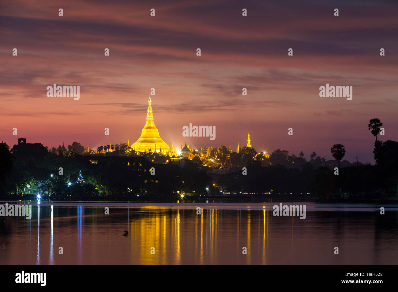 Shwedagon pagoda at sunset, as seen from Kandawgyi lake, Yangon, Myanmar Stock Photo