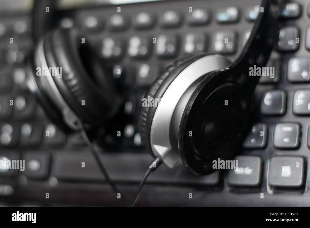 Headphones on laptop keyboard Stock Photo Alamy