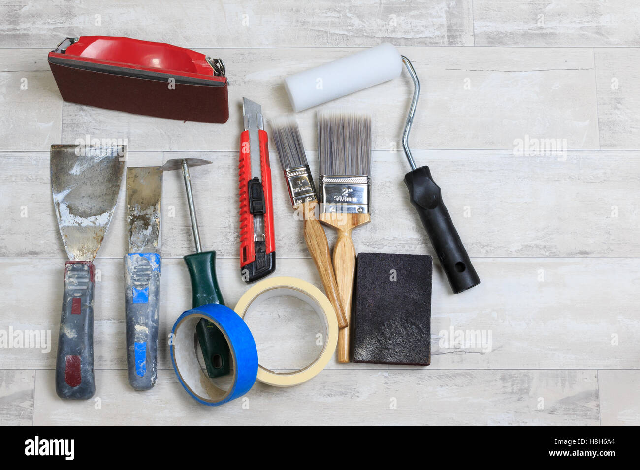 Paint scrapers, sanding blocks, masking tape, paint roller and brush's