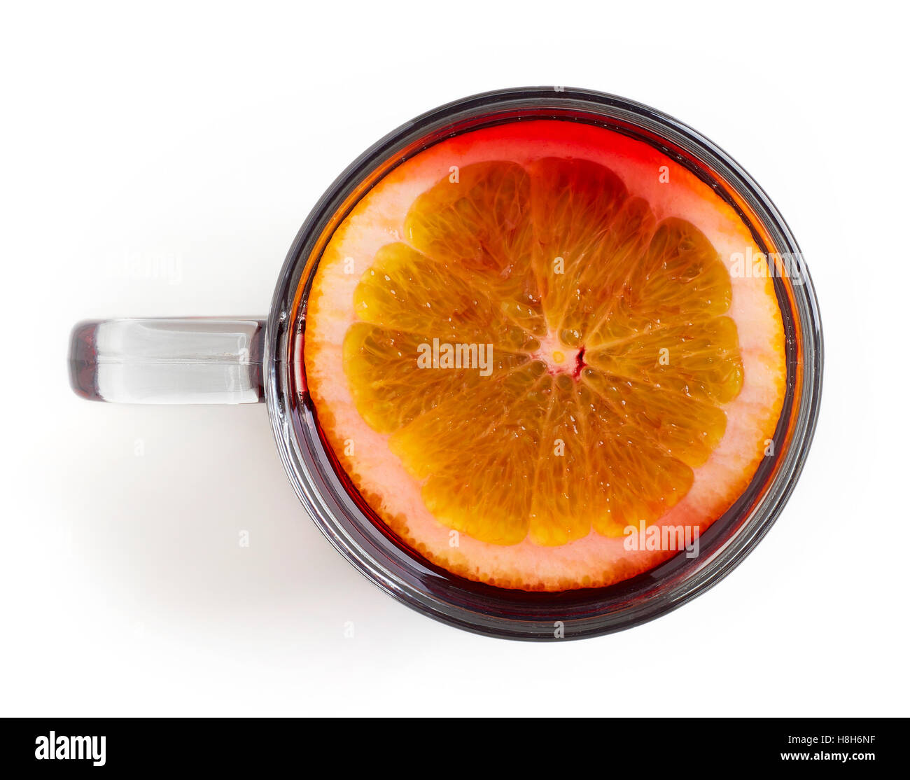 Hot red mulled wine with orange slice isolated on white background, top