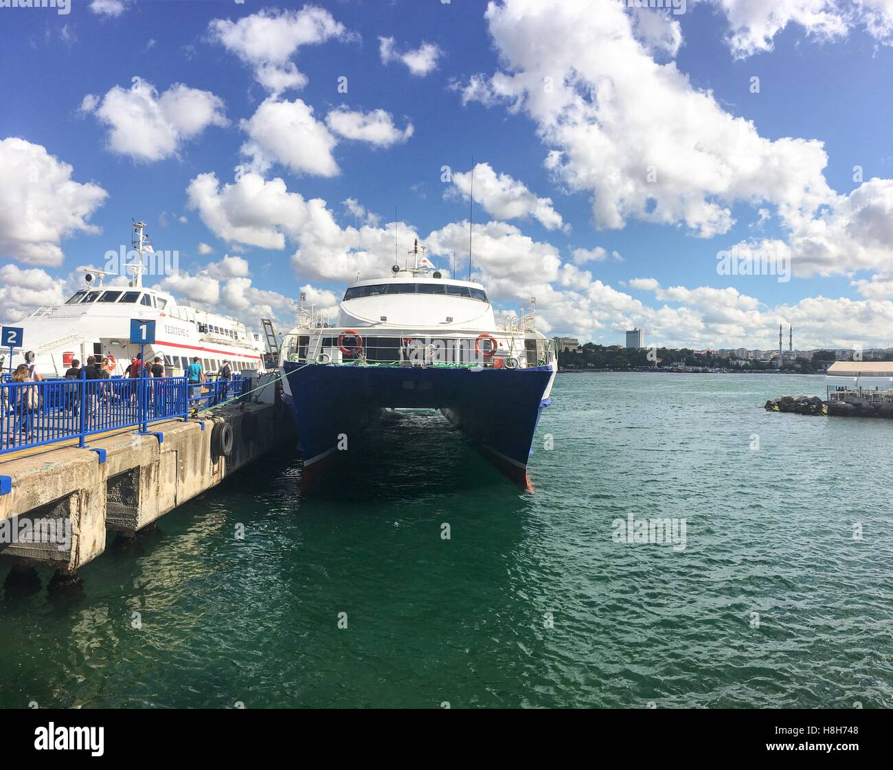 Fast ferry boat at the Kadikoy port. Boats travelling between the European and Asian ports of Istanbul. Commercial name of boat company is IDO. Stock Photo