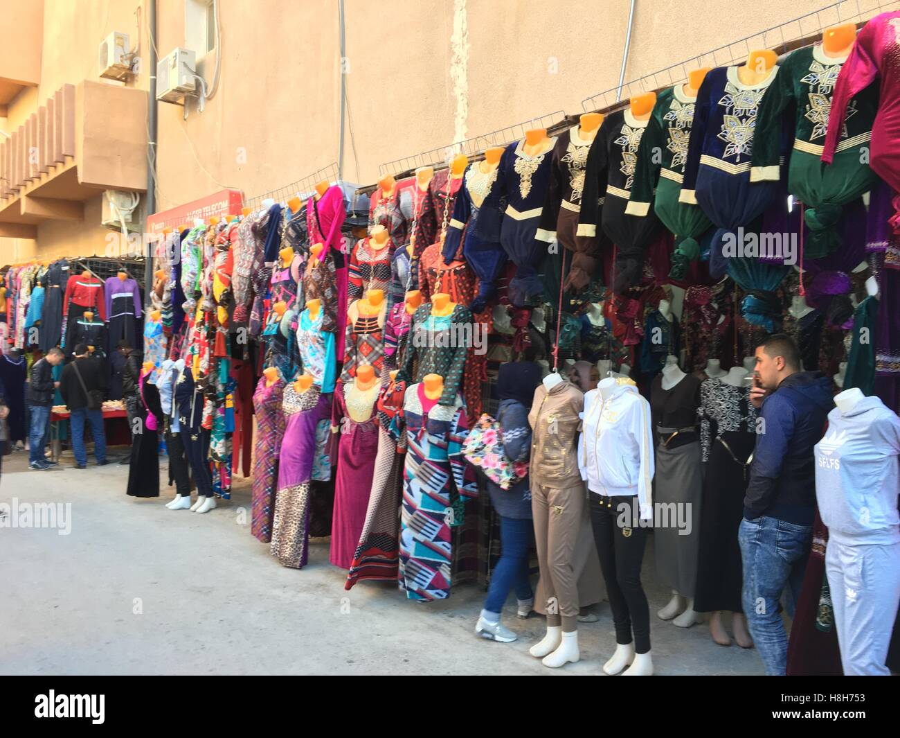 OUARGLA, ALGERIA - 27 AGU 2016: A market(souk) bazaar in touristic city Ouargla Algeria. Traditional cloth souvenir market is the one of the attaction Stock Photo