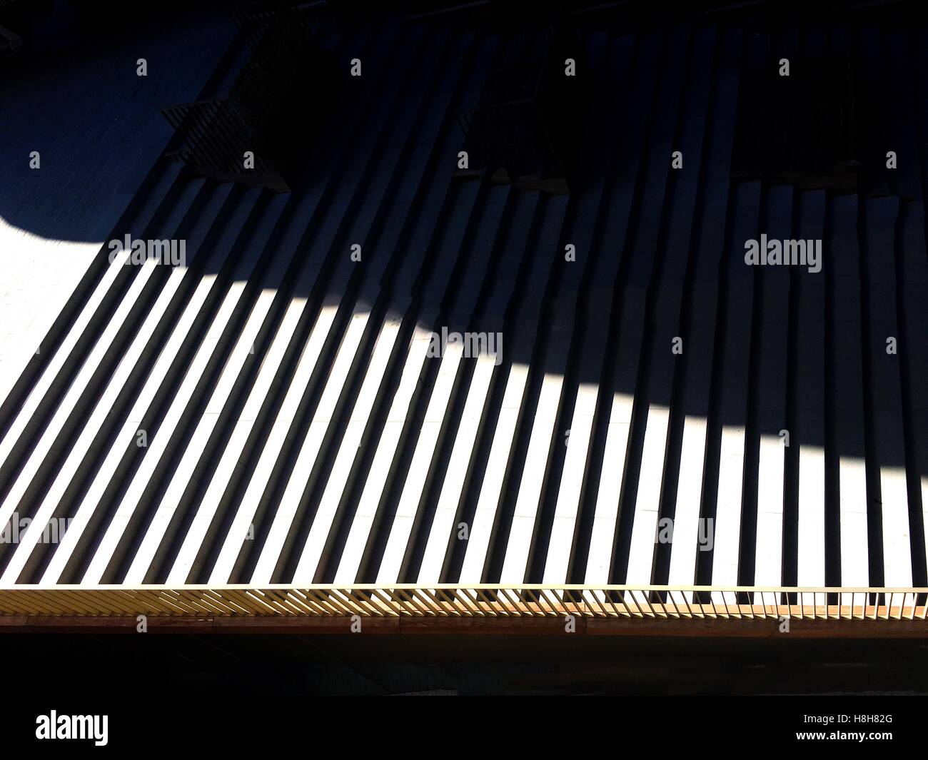 black and white shadow strips. Structural graphic shadow falling from the semi open roof. Stock Photo