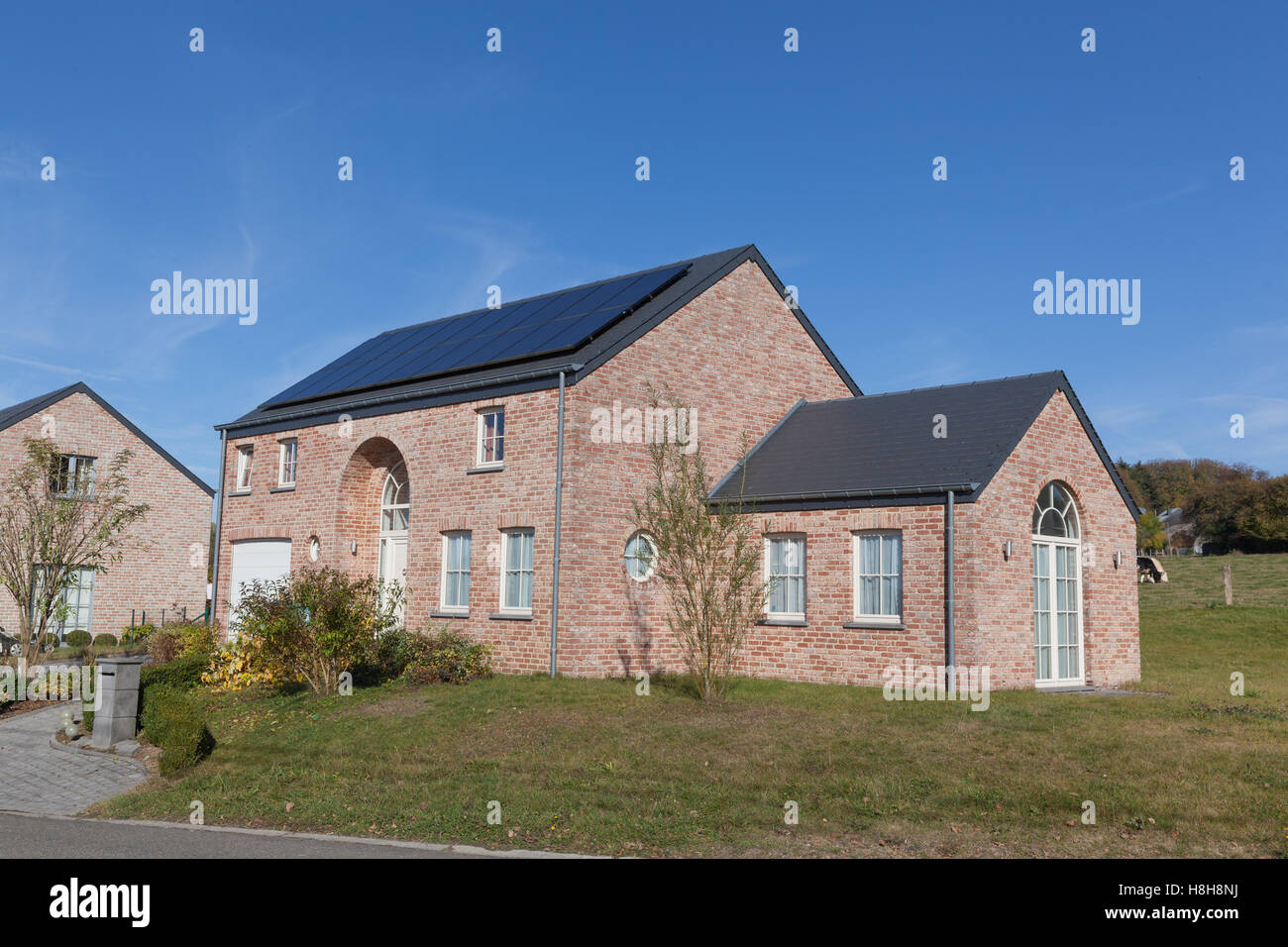 Modern house with solar panels for alternative energy Stock Photo