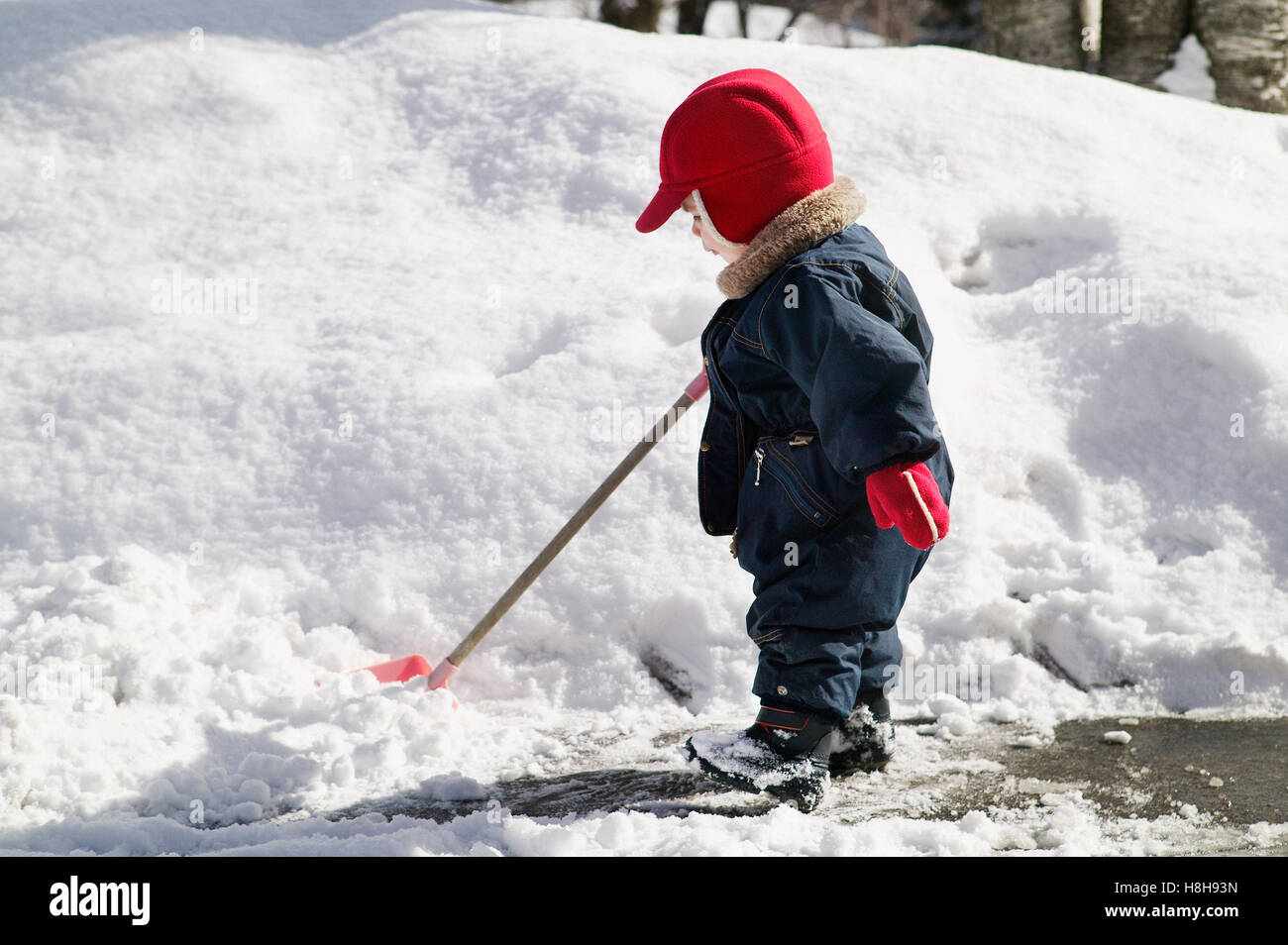 young boy shoveling snow Stock Photo Alamy