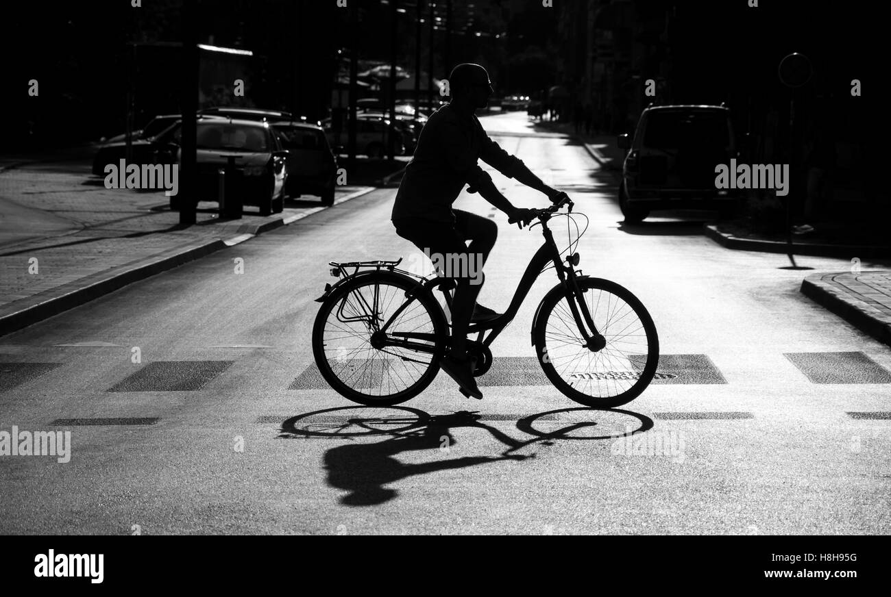 Cyclist on bicycle crossing the street Stock Photo Alamy