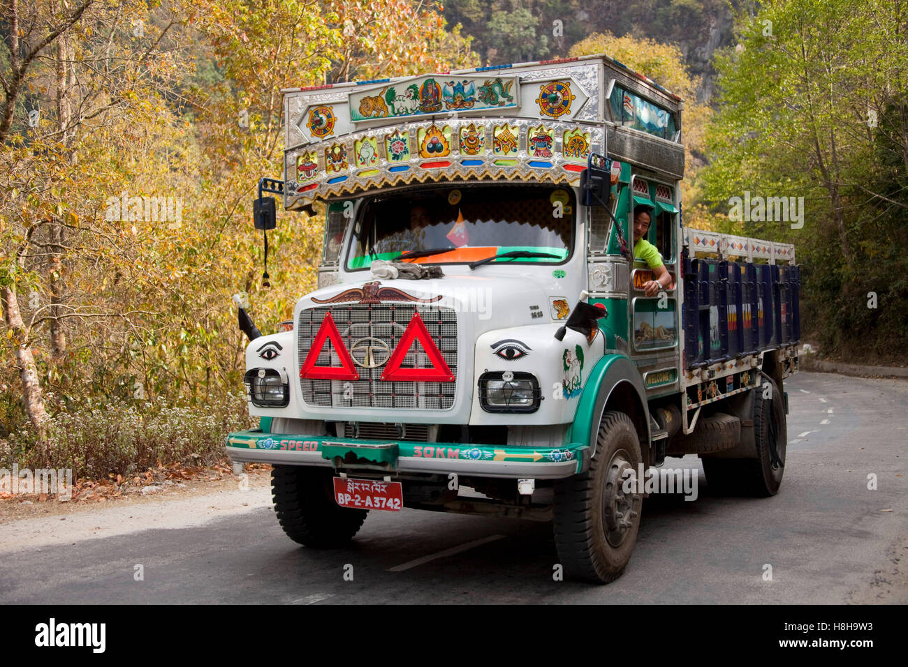 Decorated colourful heavy goods lorry TATA in mountain road, Bhutan ...