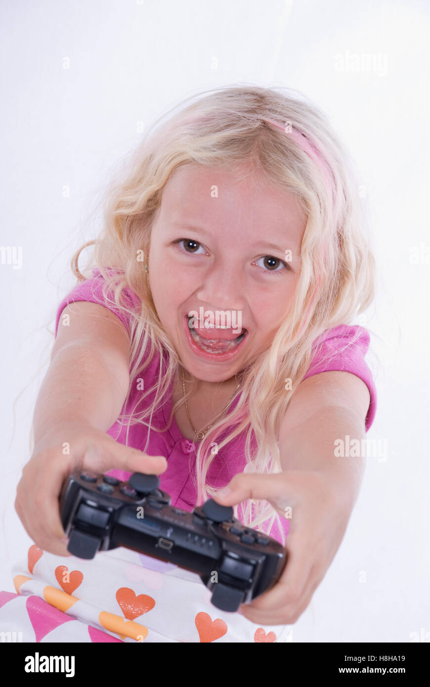 Girl, 7 years old, playing on Playstation Stock Photo