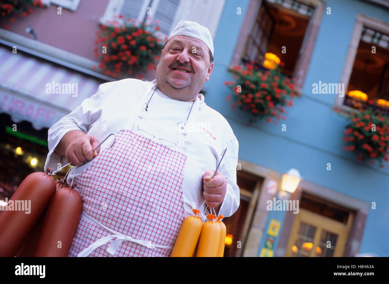 Butcher Gilbert Schluraff in front of Metzgerstuwa tavern, restaurant, sausage, Soultz, Alsace, France, Europe Stock Photo