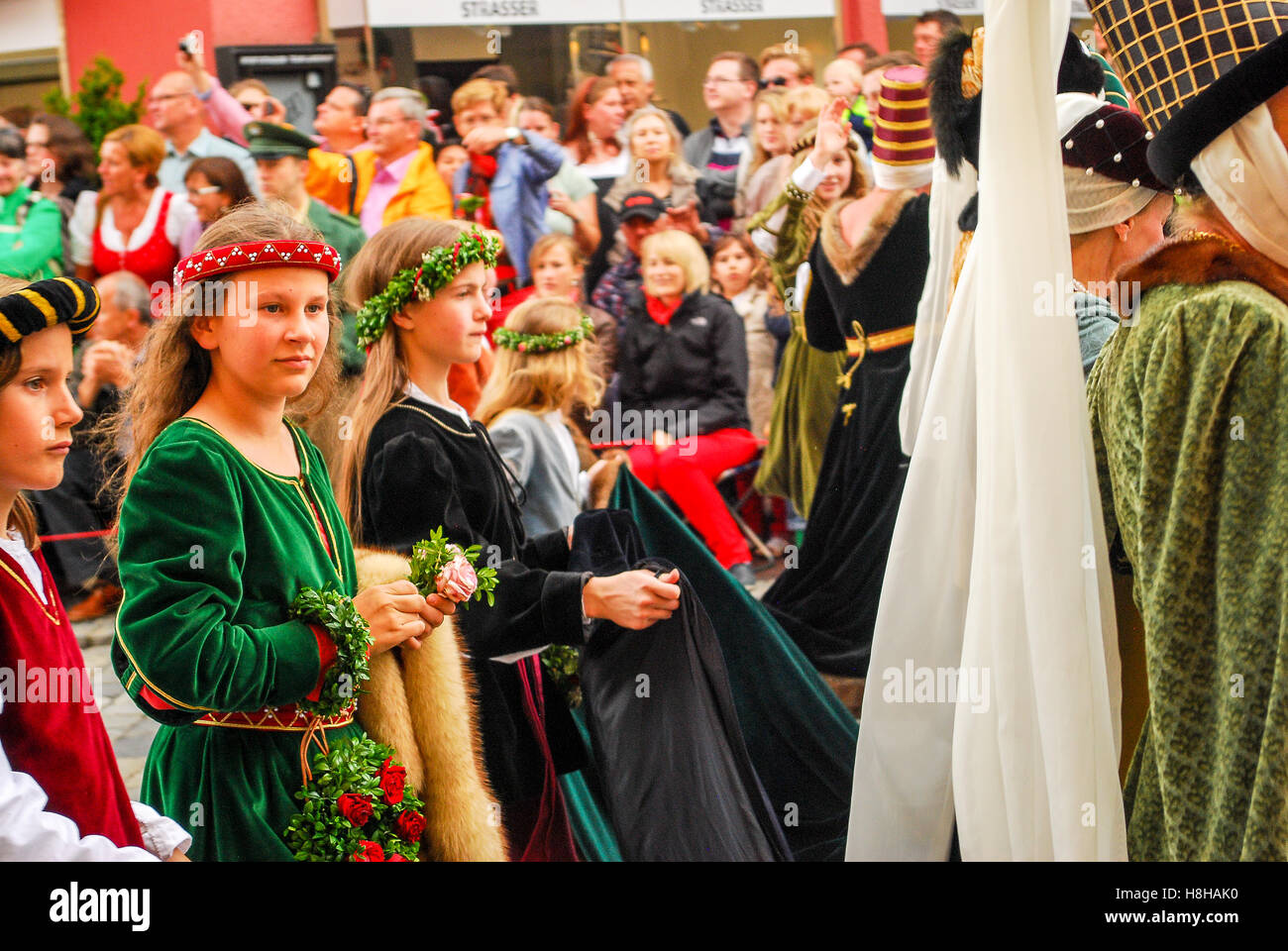 Girls  in medieval costumes walk at the start of the parade during the Landshuter Hochzeit pageant Stock Photo