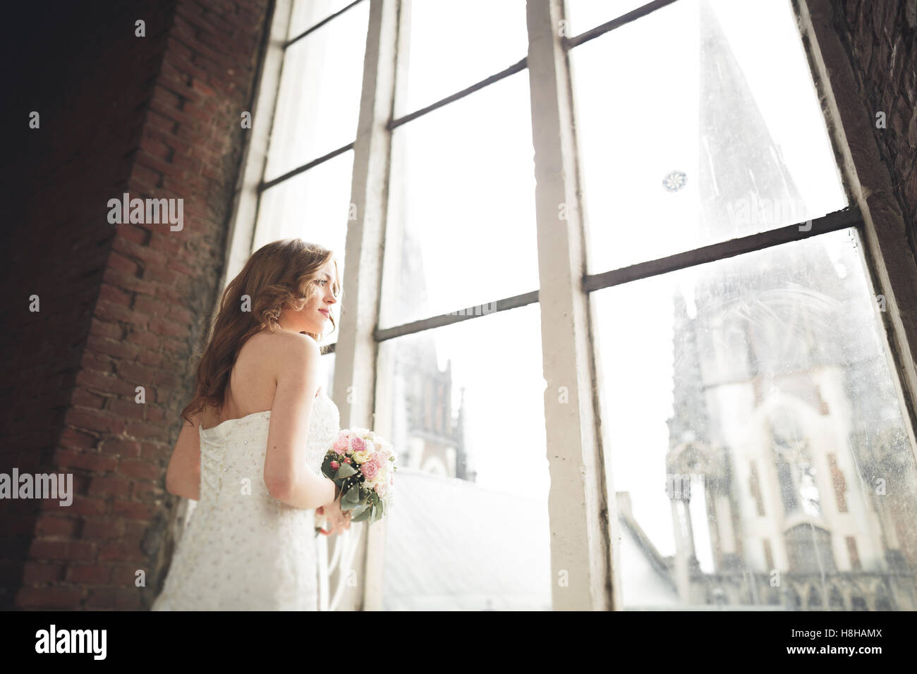 Elegant Beautiful Wedding Bride Posing Near Great Window Arch Stock