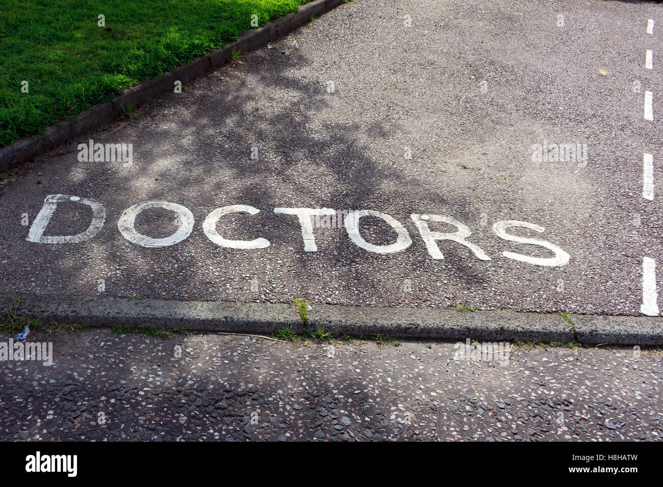 The words Doctors parking painted on the tarmac floor of the parking bay Stock Photo