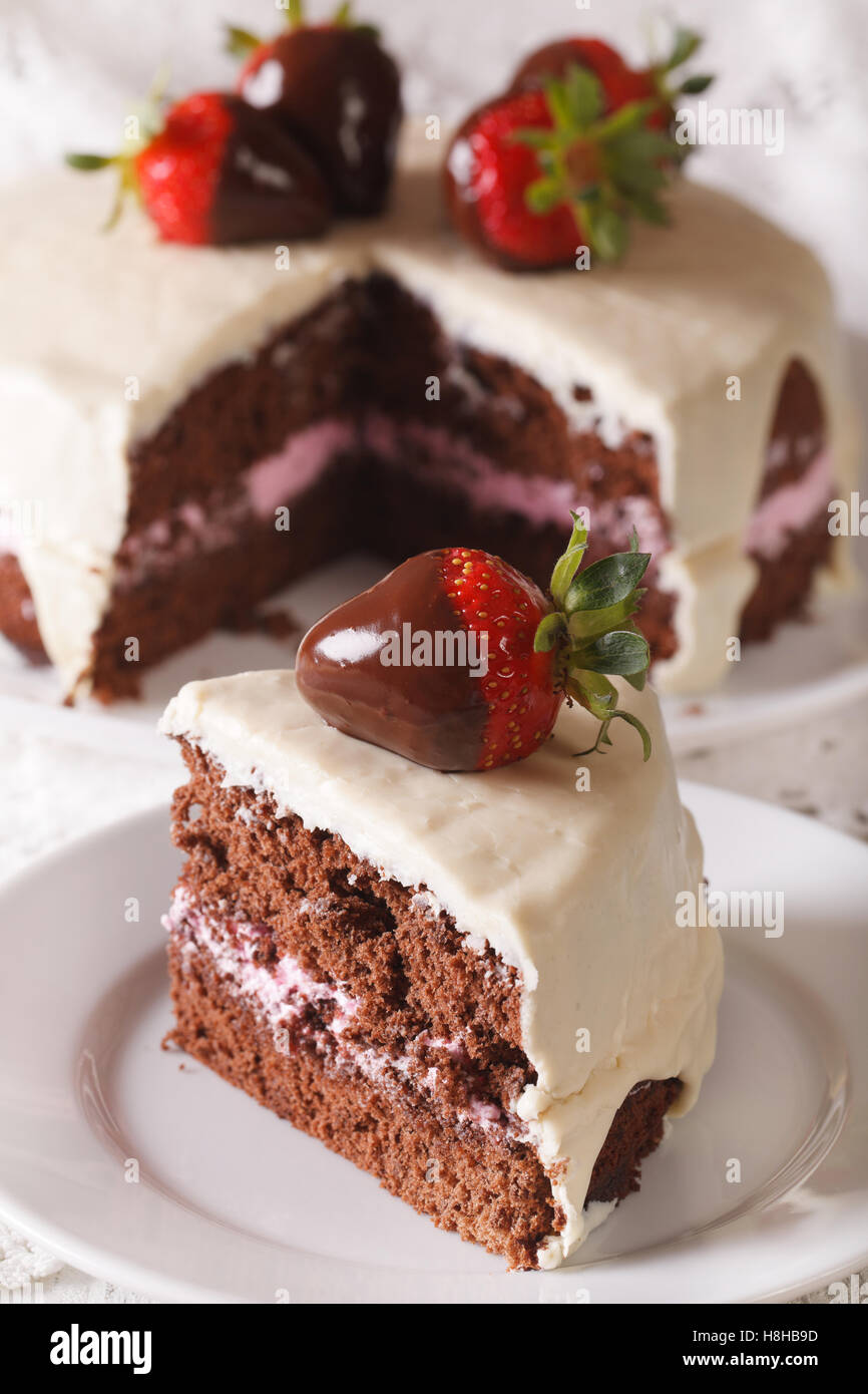 piece of strawberry chocolate cake with white chocolate icing macro. vertical Stock Photo