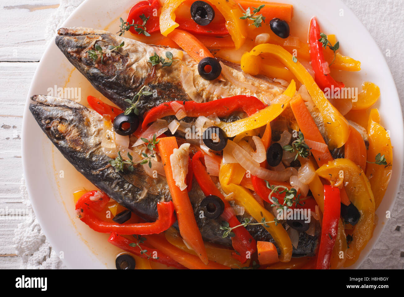 Escabeche of mackerel fish with vegetables closeup on a plate on the