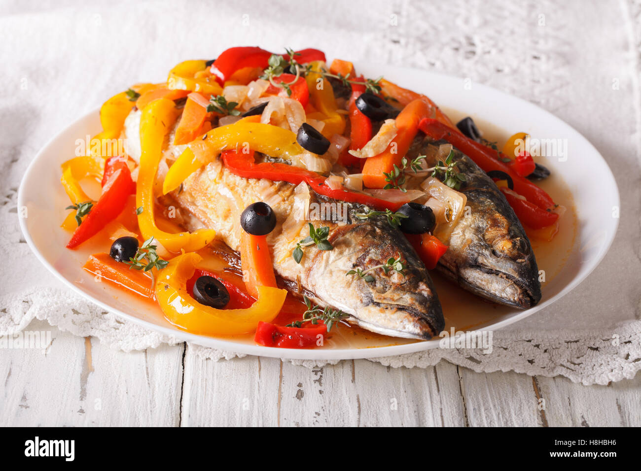 Latin American Food escabeche of mackerel fish with vegetables closeup on a plate on the table