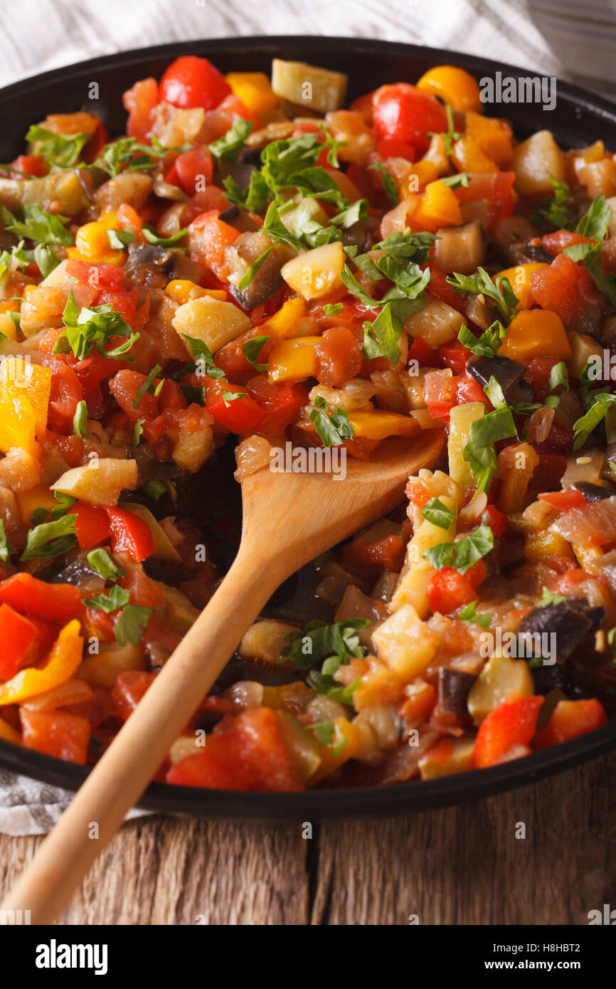 Spanish cuisine: vegetable stew Pisto manchego macro on a plate on the table. vertical Stock Photo