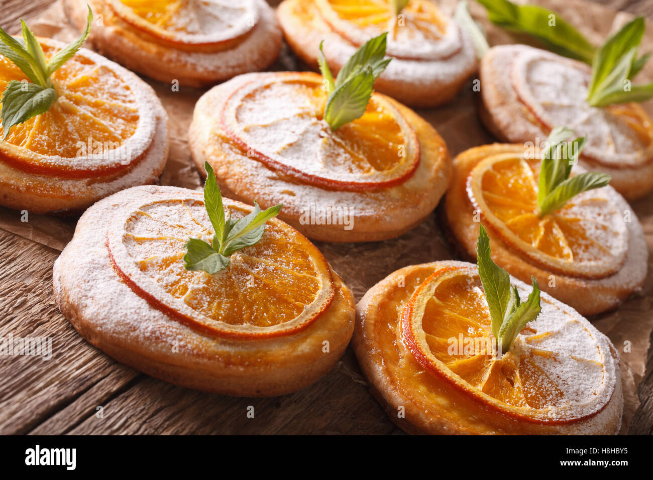 Tasty cookies with orange slices and mint close-up on the table. horizontal Stock Photo