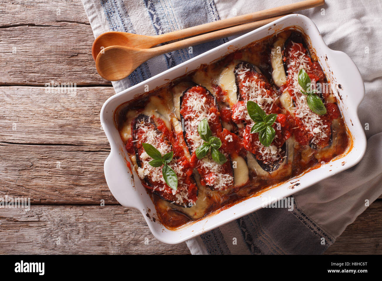 Italian eggplant baked with mozzarella in tomato sauce close up in