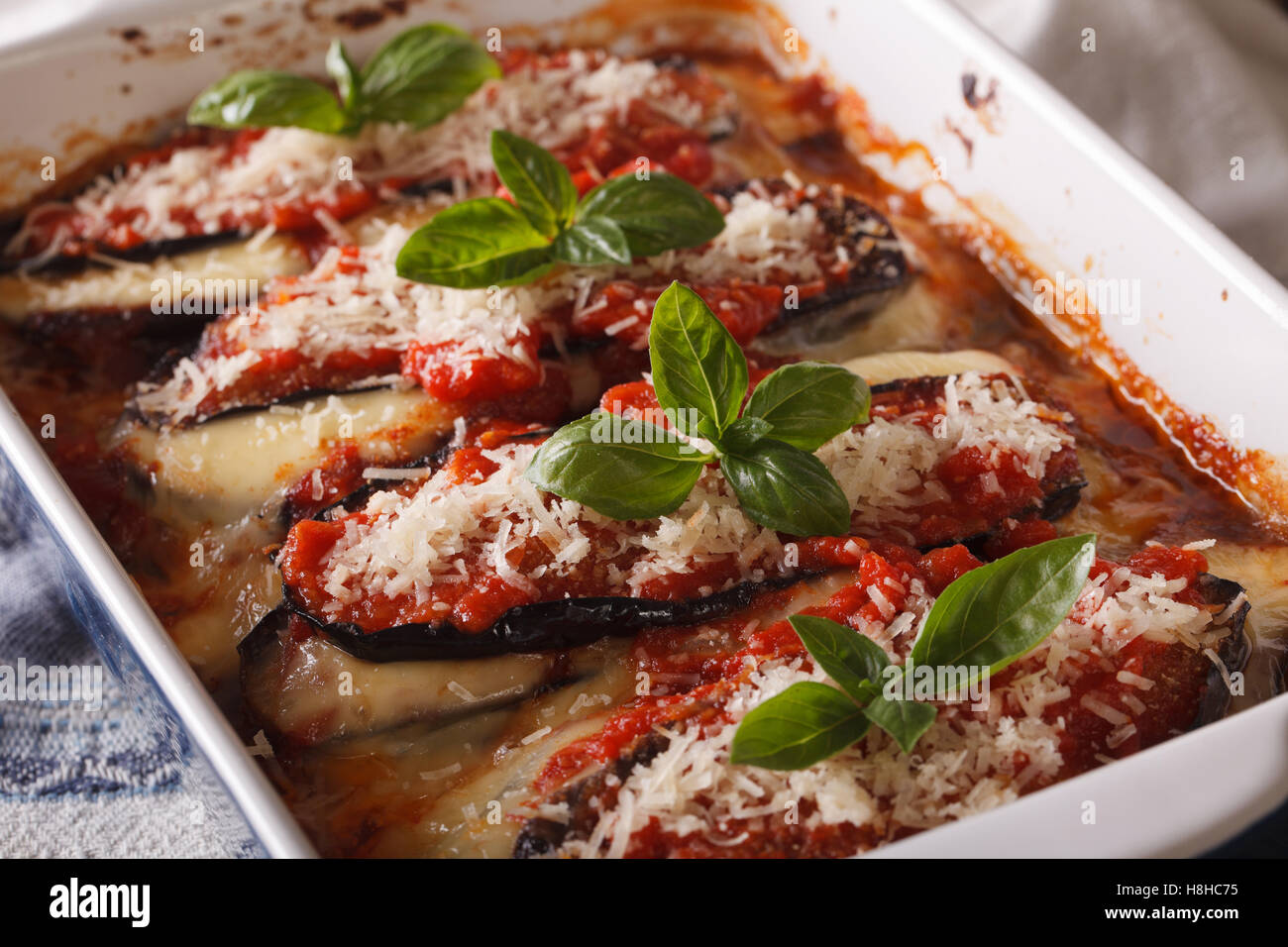 Delicious eggplant alla Parmigiana Melanzane close up in baking dish. horizontal Stock Photo