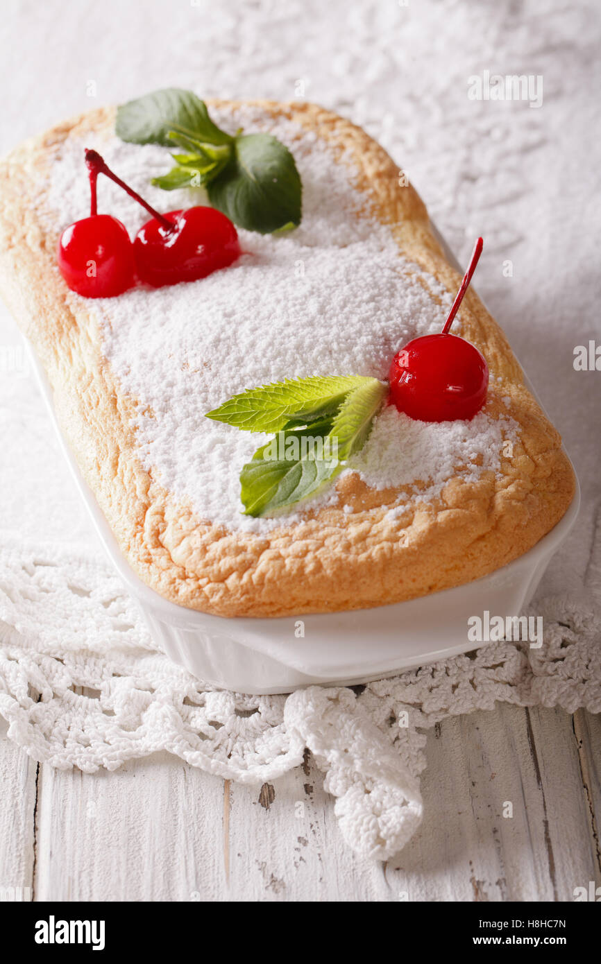 Austrian dessert Salzburger Nockerln with cherries close up in baking dish. vertical Stock Photo
