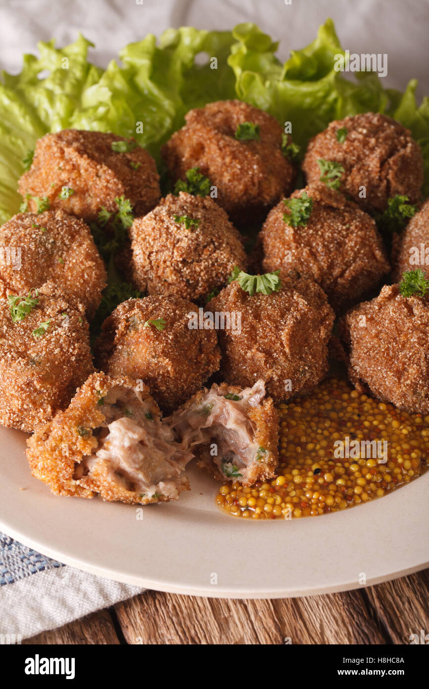 Bitterballen veal with mustard on a plate close-up on the table. vertical Stock Photo