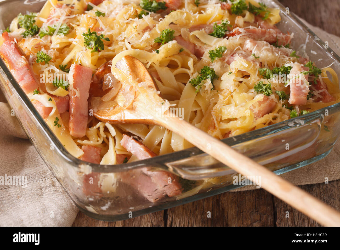 Austrian cuisine: Schinkenfleckerln macro in baking dish on the table ...