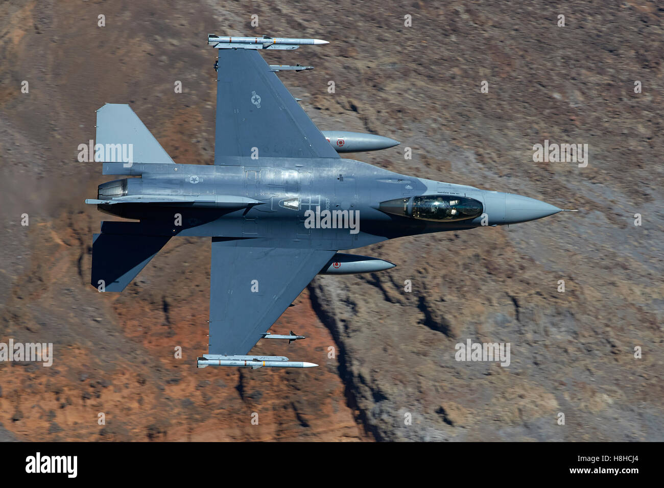 US Air Force F-16C, Flying At Low Level Through Rainbow Canyon, California. Stock Photo