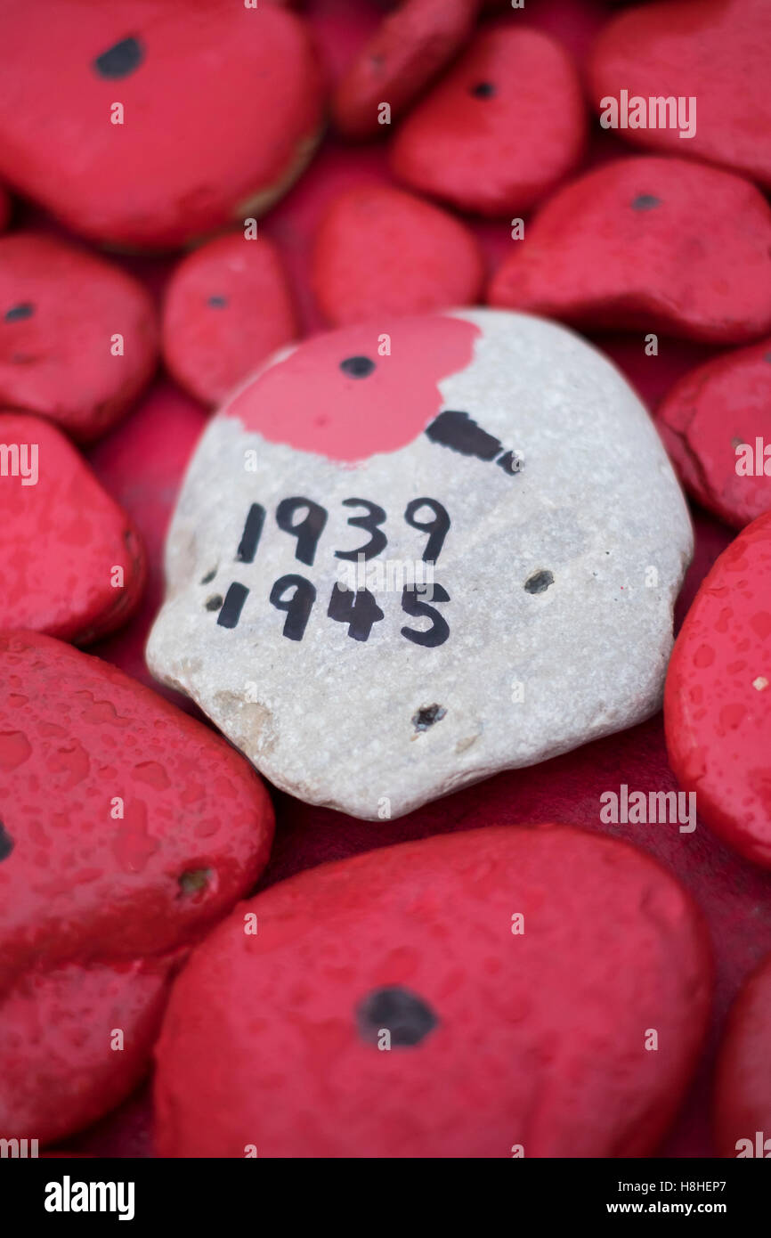 Stone poppy symbols used as part of a war memorial to commemorate the first world war Stock Photo