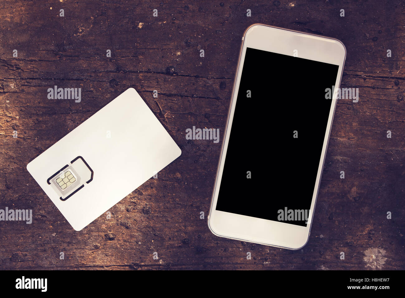 Smartphone with blank screen and mobile phone gsm SIM card on the table