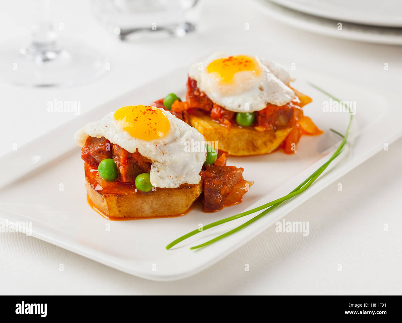 Chorizo and fried egg on a potato slice. Small tapa plate for sharing